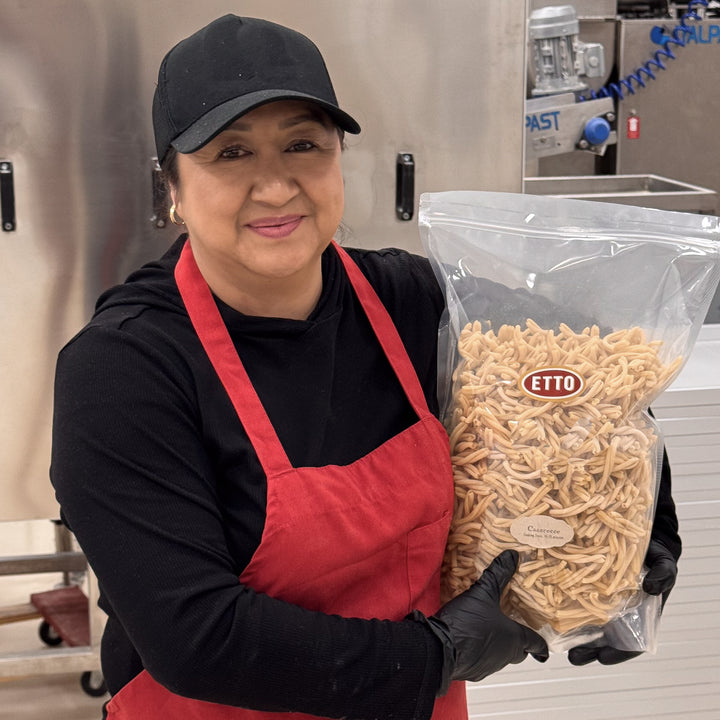 Person holding a bag of Etto pasta in a kitchen setting