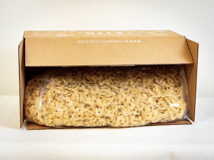 Box of pasta with a clear plastic wrap on a white background